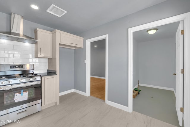 224 Ben Swain Dr, El Paso, TX 79915 - kitchen with stainless steel gas stove, wall chimney exhaust hood, decorative backsplash, dark countertops, and recessed lighting