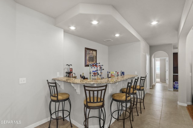 6688 Tuscany Ridge Dr, El Paso, TX 79912 - indoor wet bar with recessed lighting, arched walkways, and light tile patterned floors