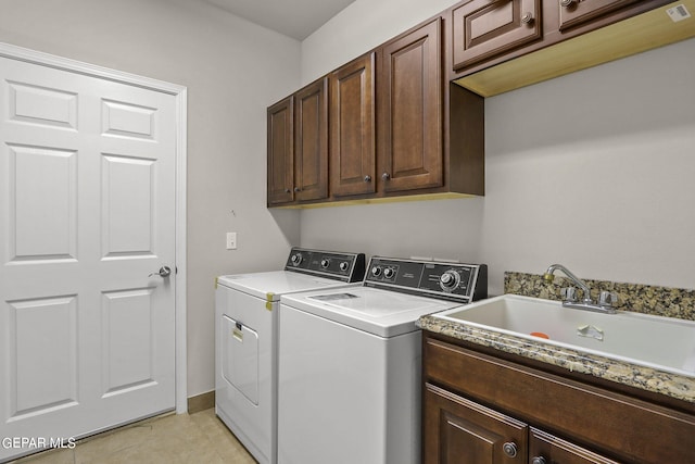 6688 Tuscany Ridge Dr, El Paso, TX 79912 - laundry area with washing machine and dryer, cabinet space, and light tile patterned floors