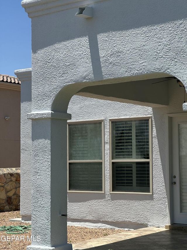 6688 Tuscany Ridge Dr, El Paso, TX 79912 - exterior view of stucco siding and arched walkways