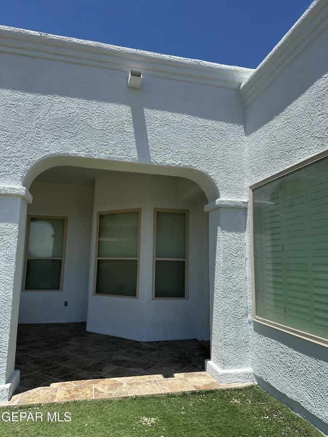 6688 Tuscany Ridge Dr, El Paso, TX 79912 - view of property exterior with stucco siding and a patio