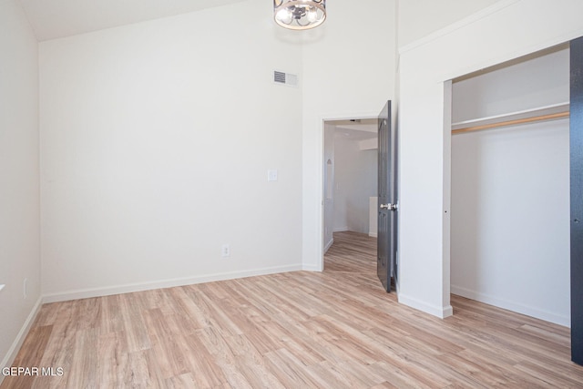 448 Ghost Flower St, Horizon City, TX 79928 - unfurnished bedroom with light wood-type flooring, a closet, and a chandelier