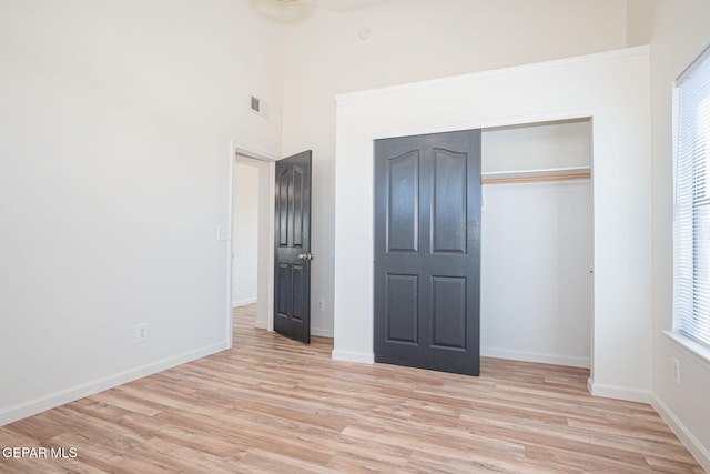 448 Ghost Flower St, Horizon City, TX 79928 - unfurnished bedroom featuring light wood finished floors, a closet, and a high ceiling