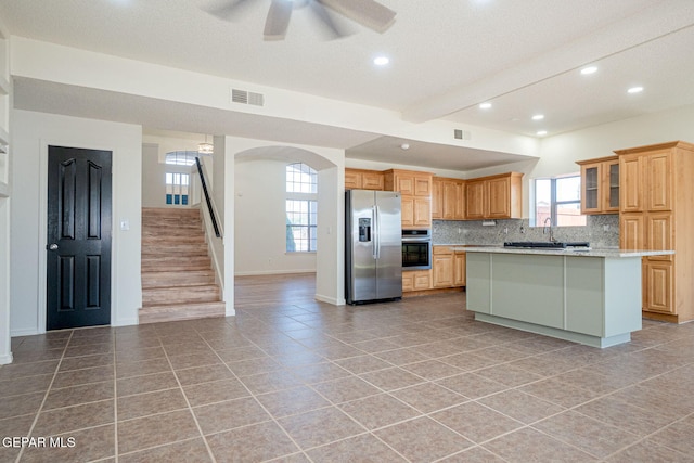 448 Ghost Flower St, Horizon City, TX 79928 - kitchen with appliances with stainless steel finishes, recessed lighting, ceiling fan, decorative backsplash, and a kitchen island
