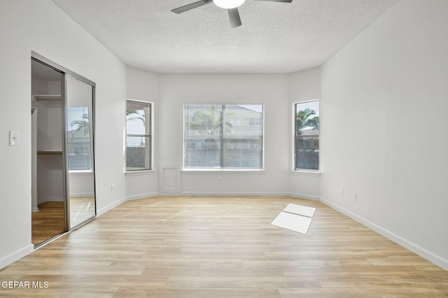 448 Ghost Flower St, Horizon City, TX 79928 - unfurnished bedroom with a textured ceiling, light wood finished floors, a closet, and a ceiling fan