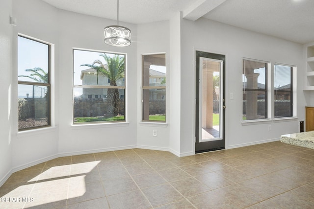 448 Ghost Flower St, Horizon City, TX 79928 - unfurnished dining area with plenty of natural light, tile patterned floors, a chandelier, and vaulted ceiling