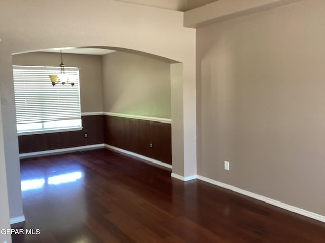 683 Juan Munoz Ct, El Paso, TX 79932 - spare room featuring wood finished floors, a chandelier, and arched walkways