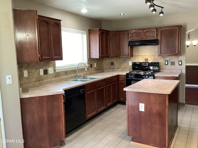 683 Juan Munoz Ct, El Paso, TX 79932 - kitchen with black appliances, under cabinet range hood, light countertops, and tasteful backsplash