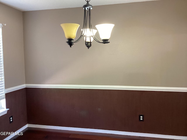 683 Juan Munoz Ct, El Paso, TX 79932 - unfurnished room featuring a chandelier and dark wood-type flooring