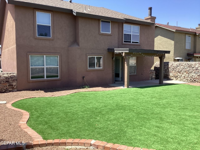 683 Juan Munoz Ct, El Paso, TX 79932 - back of property featuring a patio area, stucco siding, roof with shingles, and a yard