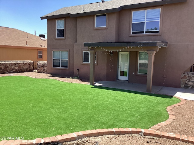 683 Juan Munoz Ct, El Paso, TX 79932 - back of property with stucco siding, a patio area, a yard, and a shingled roof