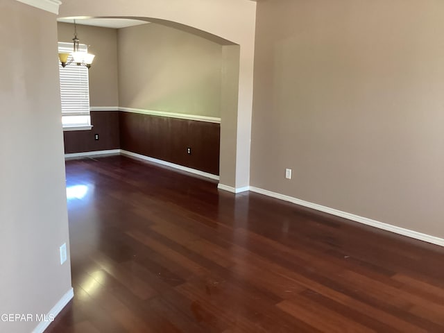 683 Juan Munoz Ct, El Paso, TX 79932 - unfurnished room featuring wood finished floors, a chandelier, and arched walkways