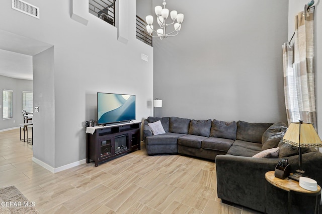 13594 Gatton St, El Paso, TX 79928 - living area featuring a chandelier, light wood-style floors, and a towering ceiling