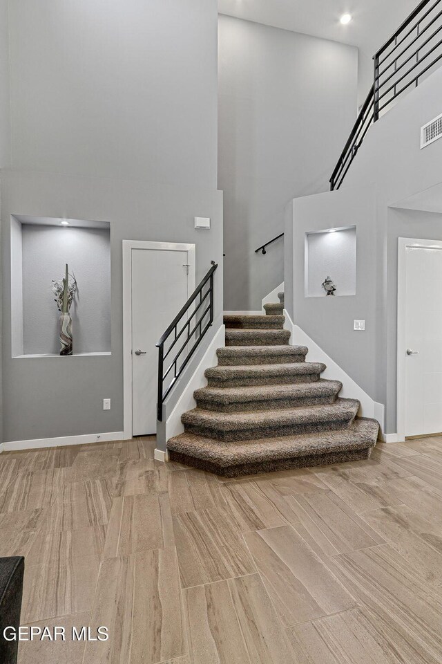 13594 Gatton St, El Paso, TX 79928 - staircase with a towering ceiling and baseboards