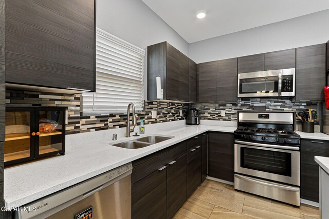 13594 Gatton St, El Paso, TX 79928 - kitchen with appliances with stainless steel finishes, decorative backsplash, modern cabinets, dark brown cabinets, and recessed lighting