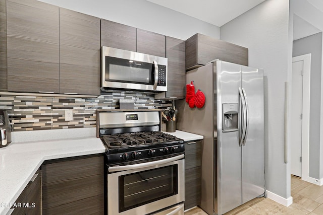 13594 Gatton St, El Paso, TX 79928 - kitchen featuring stainless steel appliances, tasteful backsplash, dark brown cabinets, and modern cabinets