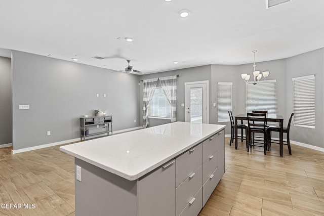 13594 Gatton St, El Paso, TX 79928 - kitchen featuring a kitchen island, a chandelier, recessed lighting, a ceiling fan, and gray cabinetry