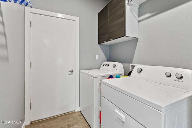 13594 Gatton St, El Paso, TX 79928 - washroom featuring independent washer and dryer, light wood finished floors, and cabinet space