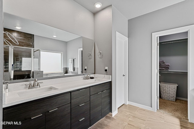 13594 Gatton St, El Paso, TX 79928 - full bath featuring double vanity, a shower stall, and a walk in closet