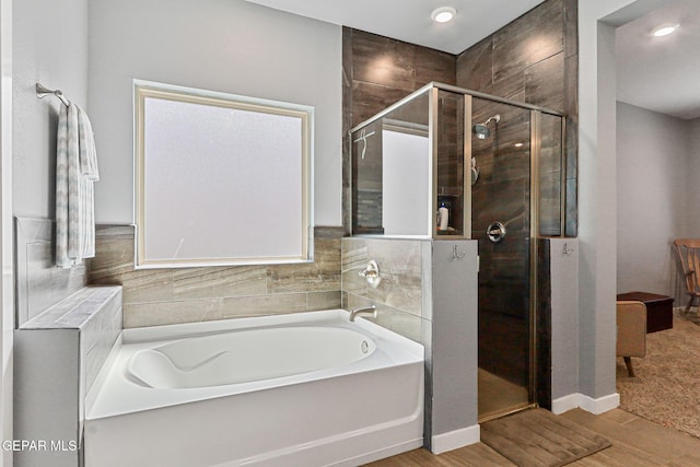 13594 Gatton St, El Paso, TX 79928 - bathroom with a bath, a stall shower, wood finished floors, and recessed lighting