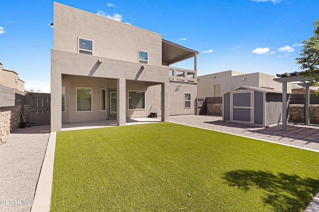 13594 Gatton St, El Paso, TX 79928 - rear view of property with a storage unit, a balcony, a patio, stucco siding, and a fenced backyard