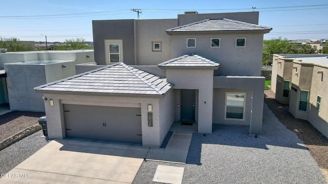 13594 Gatton St, El Paso, TX 79928 - view of front of property with a tile roof, stucco siding, driveway, and an attached garage