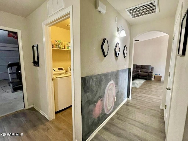 813 Nuevo Desierto Dr, Horizon City, TX 79928 - corridor featuring arched walkways, wood finished floors, and washer and dryer