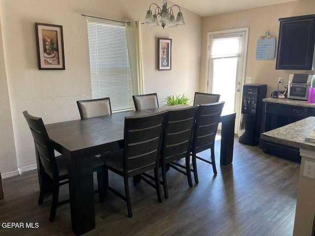 813 Nuevo Desierto Dr, Horizon City, TX 79928 - dining area with a chandelier and dark wood-type flooring