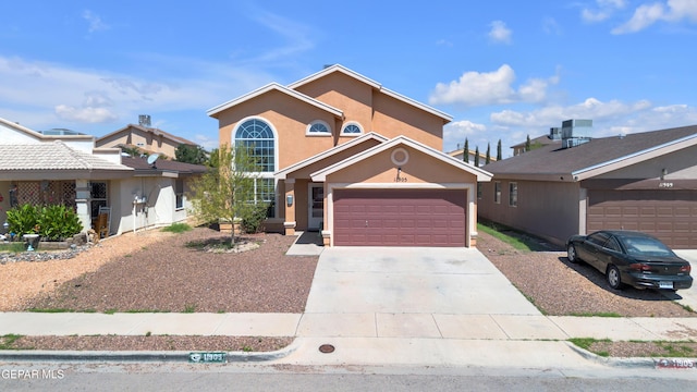 11905 Jim Webb Dr, El Paso, TX 79934 - traditional-style house with concrete driveway, stucco siding, and an attached garage
