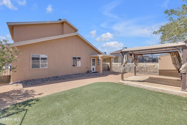 11905 Jim Webb Dr, El Paso, TX 79934 - back of property featuring a lawn, stucco siding, and a gazebo