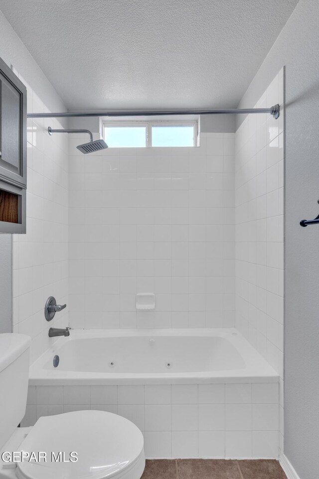 11905 Jim Webb Dr, El Paso, TX 79934 - bathroom featuring tiled shower / bath combo and a textured ceiling