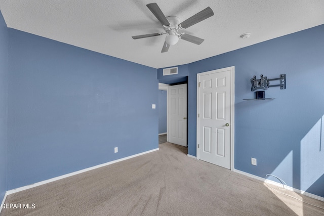 11905 Jim Webb Dr, El Paso, TX 79934 - unfurnished bedroom with carpet, a textured ceiling, and ceiling fan