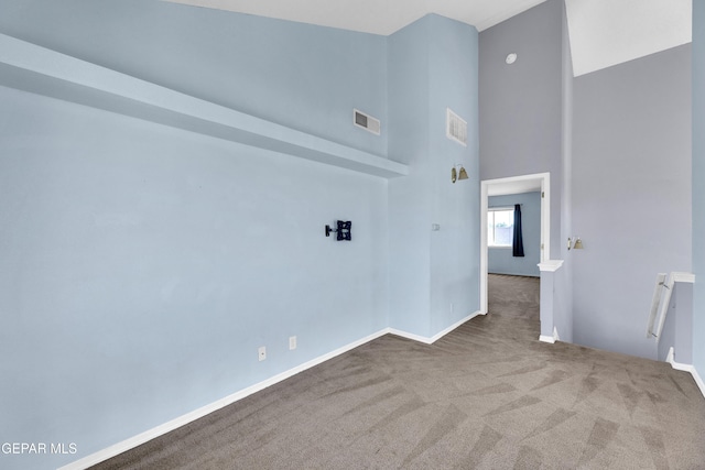 11905 Jim Webb Dr, El Paso, TX 79934 - empty room featuring carpet and a towering ceiling