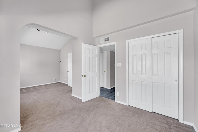 11905 Jim Webb Dr, El Paso, TX 79934 - unfurnished bedroom featuring carpet flooring, a closet, a high ceiling, and arched walkways