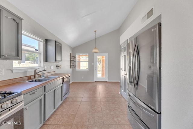 11905 Jim Webb Dr, El Paso, TX 79934 - kitchen featuring appliances with stainless steel finishes, gray cabinetry, lofted ceiling, and healthy amount of natural light