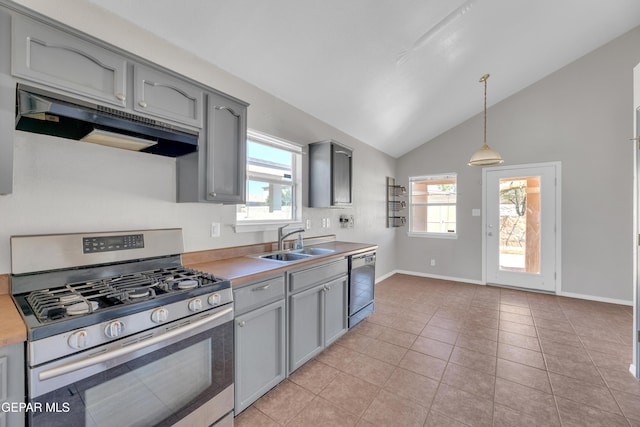 11905 Jim Webb Dr, El Paso, TX 79934 - kitchen with gas stove, under cabinet range hood, black dishwasher, gray cabinetry, and vaulted ceiling