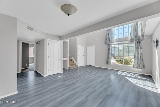 11905 Jim Webb Dr, El Paso, TX 79934 - unfurnished living room with plenty of natural light, wood finished floors, and stairway