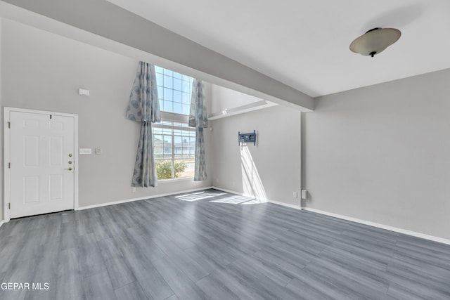 11905 Jim Webb Dr, El Paso, TX 79934 - unfurnished living room featuring wood finished floors and a towering ceiling