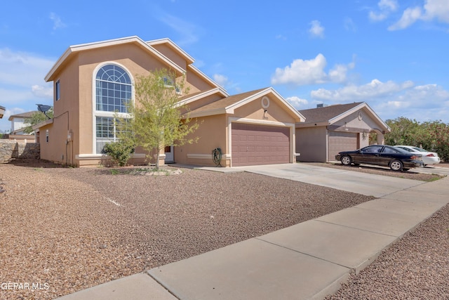 11905 Jim Webb Dr, El Paso, TX 79934 - view of front of house featuring stucco siding, an attached garage, and driveway
