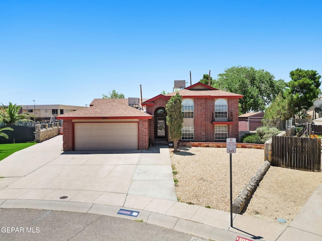 12090 Sterling Mary Way, El Paso, TX 79936 - view of front of property featuring a garage, driveway, brick siding, and a chimney