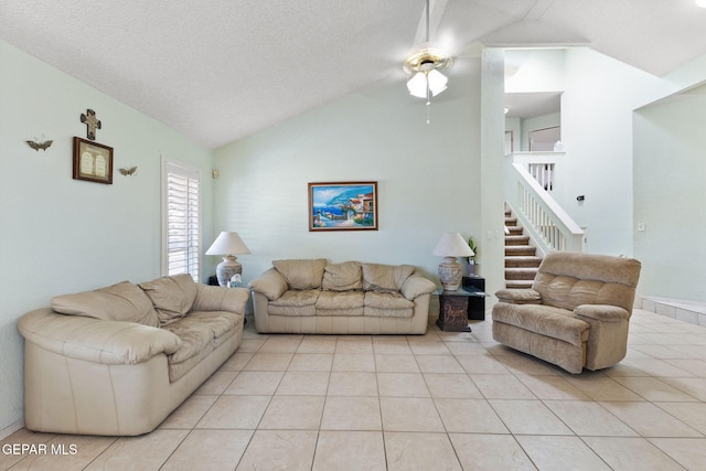 12090 Sterling Mary Way, El Paso, TX 79936 - living area featuring ceiling fan, light tile patterned floors, stairs, and high vaulted ceiling