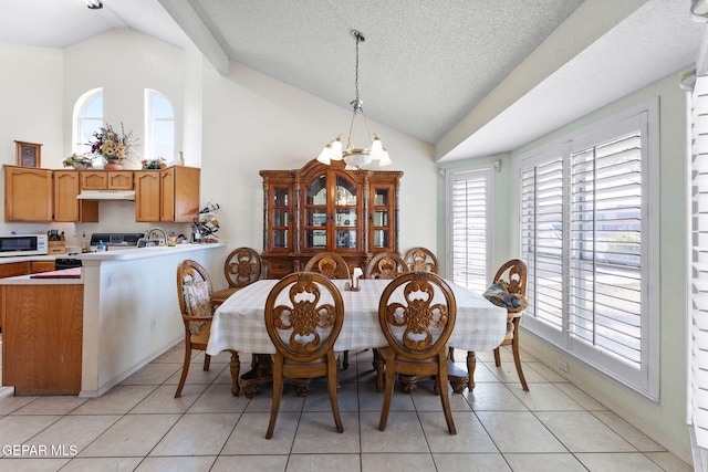 12090 Sterling Mary Way, El Paso, TX 79936 - dining space featuring a chandelier, high vaulted ceiling, light tile patterned floors, and a textured ceiling