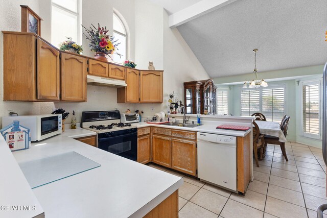 12090 Sterling Mary Way, El Paso, TX 79936 - kitchen featuring white appliances, a peninsula, under cabinet range hood, high vaulted ceiling, and a chandelier