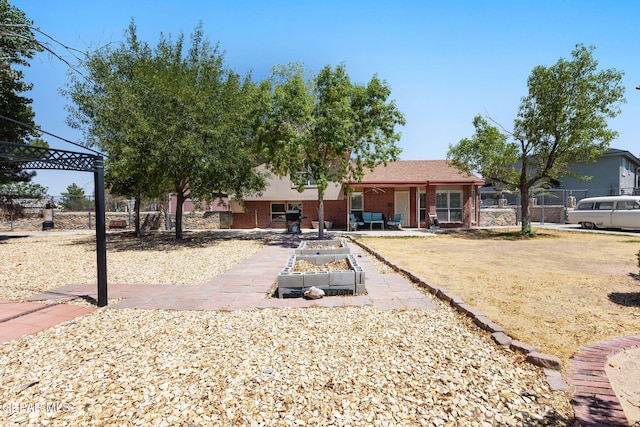 12090 Sterling Mary Way, El Paso, TX 79936 - back of property featuring a vegetable garden and brick siding