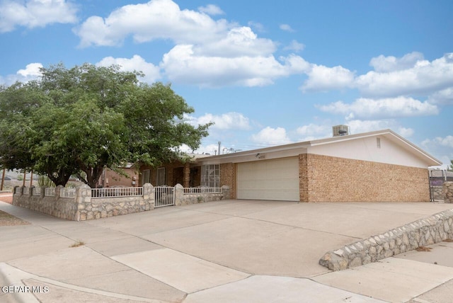 4821 Round Rock Dr, El Paso, TX 79924 - ranch-style home featuring a garage, concrete driveway, a gate, and brick siding