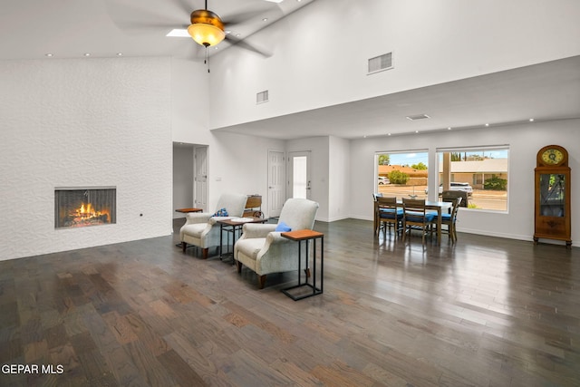 10121 Monaco Dr, El Paso, TX 79925 - living room featuring wood finished floors, a fireplace, a ceiling fan, a towering ceiling, and recessed lighting
