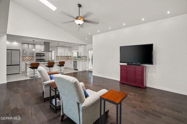 10121 Monaco Dr, El Paso, TX 79925 - living area with a ceiling fan, wood finished floors, and high vaulted ceiling