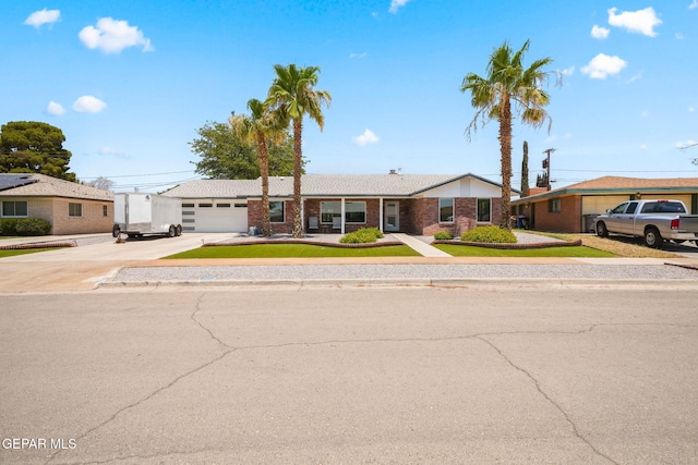 10121 Monaco Dr, El Paso, TX 79925 - ranch-style home with concrete driveway, brick siding, and an attached garage