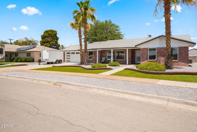 10121 Monaco Dr, El Paso, TX 79925 - ranch-style home featuring brick siding, driveway, an attached garage, and a front lawn