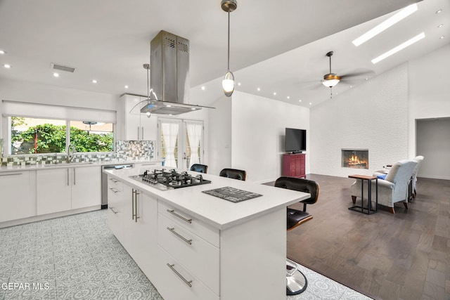10121 Monaco Dr, El Paso, TX 79925 - kitchen featuring island range hood, stainless steel appliances, recessed lighting, white cabinetry, and a center island